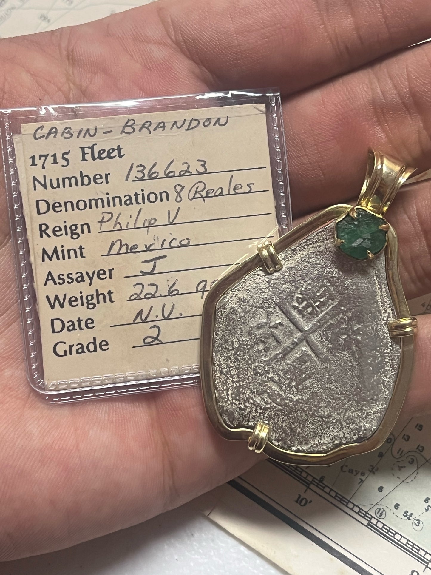 1715 Fleet 8 Reale in 14kt Mount with Large Fleet Emerald. Grade 2, 29.8 Grams total, J Assayer, Mexico City Mint, Philip V Reign, 2.55 Carat Emerald, Cobb Coin Co. Cert, Salvaged by John Brandon.